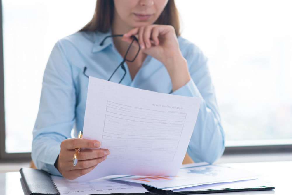Support worker reviewing medical reports and supporting evidence for an NDIS application